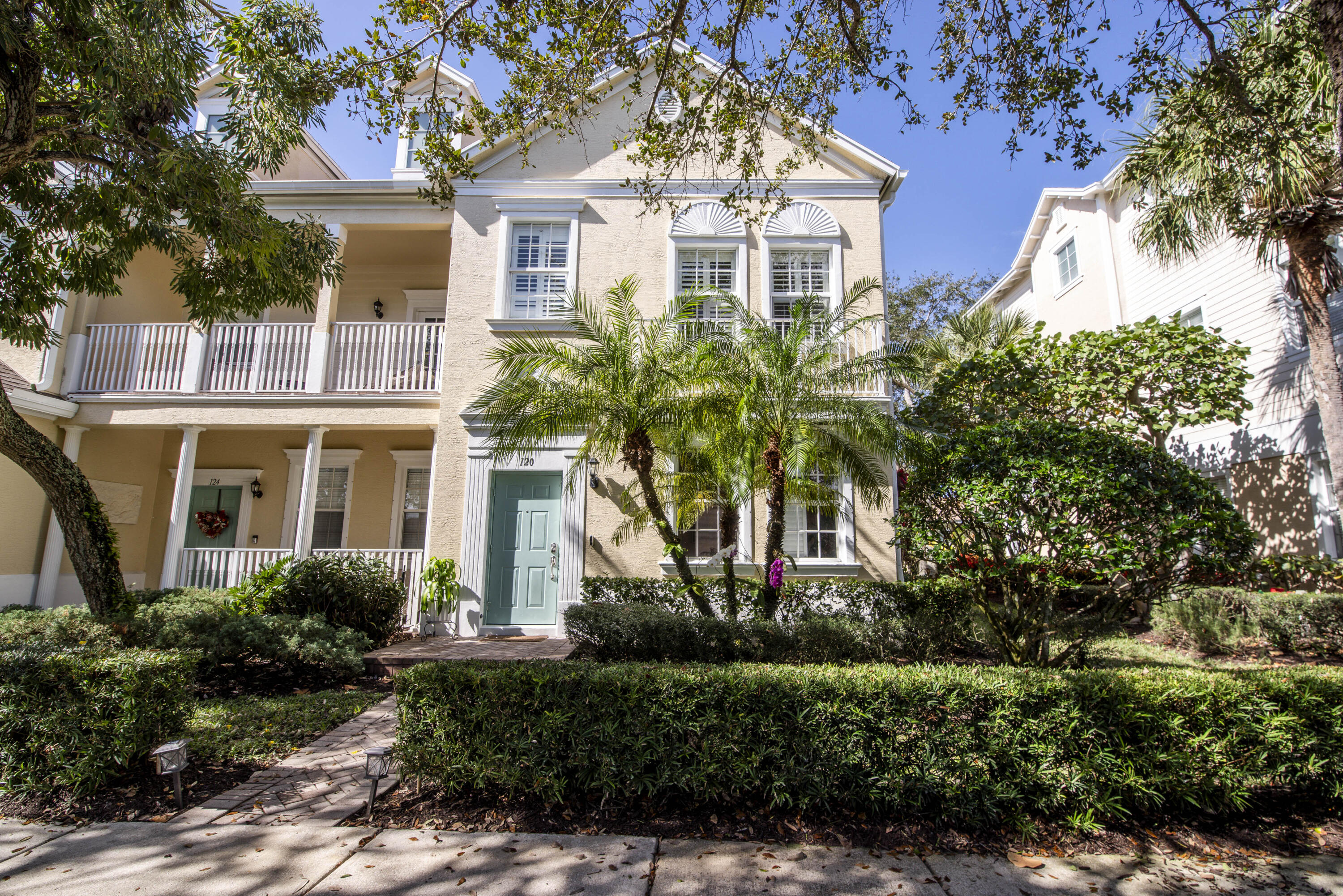 120 West Thatch Palm Circle Jupiter, FL 33458 - Photo 3 of 41 a front view of a house with a yard and trees
