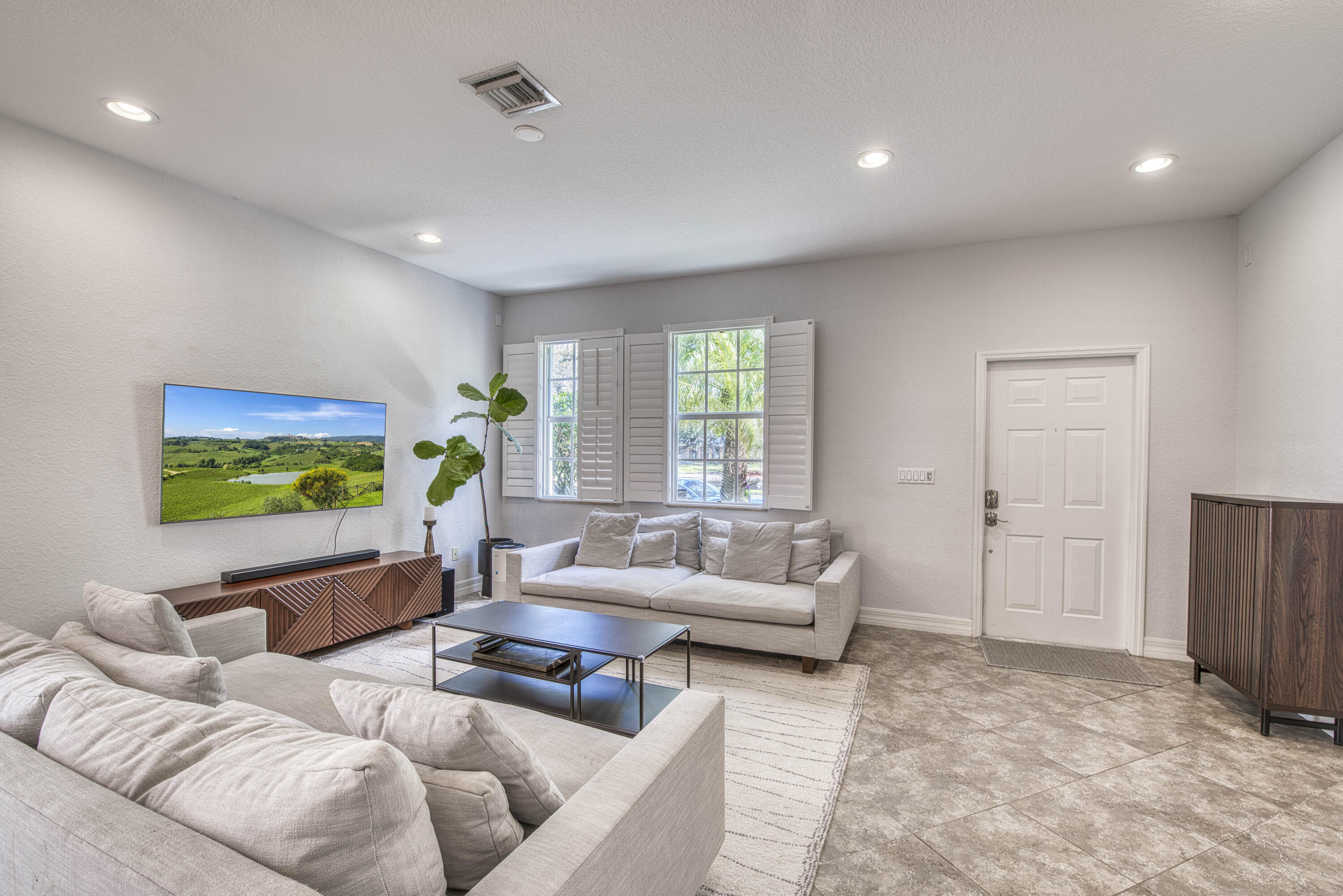 120 West Thatch Palm Circle Jupiter, FL 33458 - Photo 5 of 41 a living room with furniture and a flat screen tv