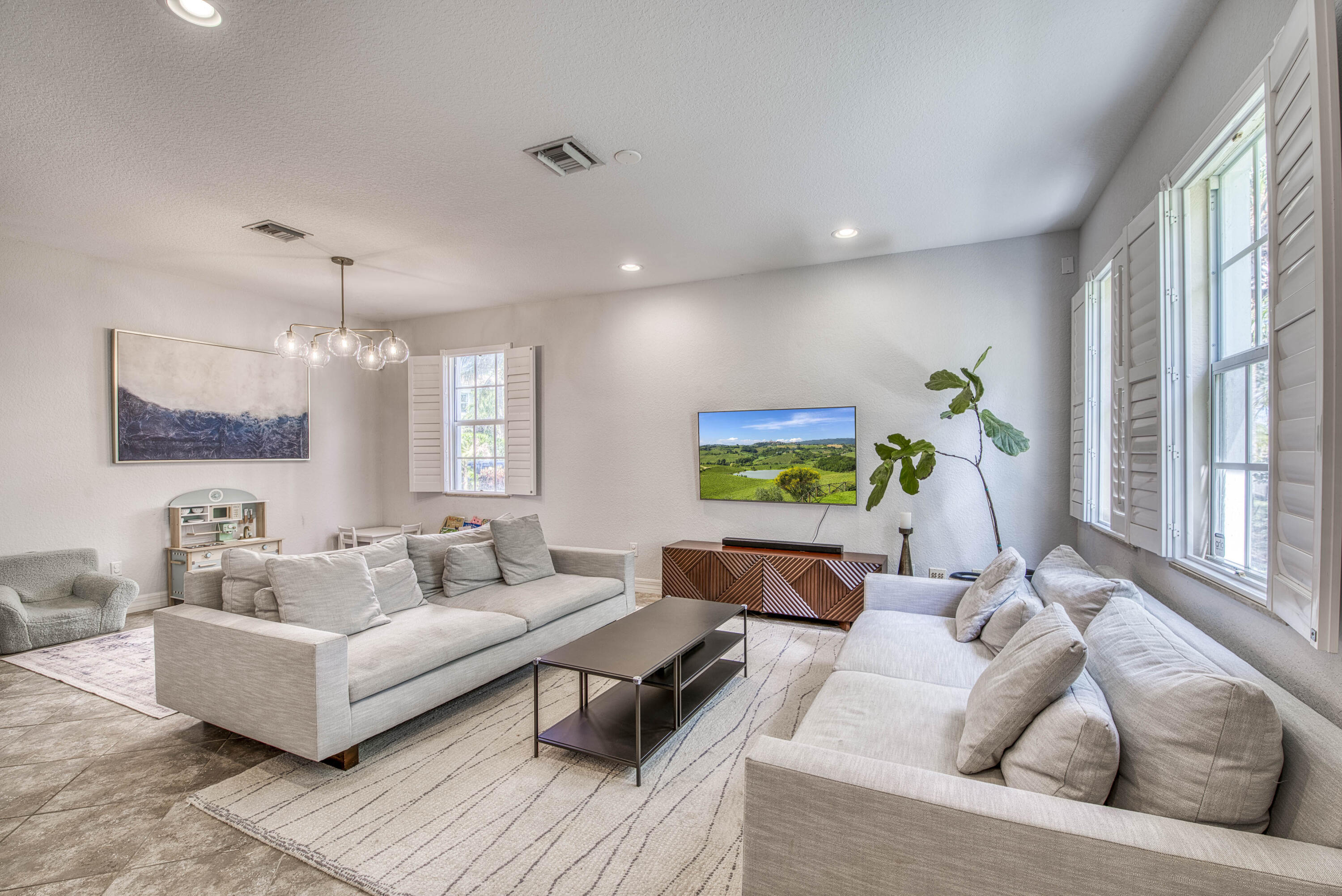 120 West Thatch Palm Circle Jupiter, FL 33458 - Photo 6 of 41 a living room with furniture and a flat screen tv