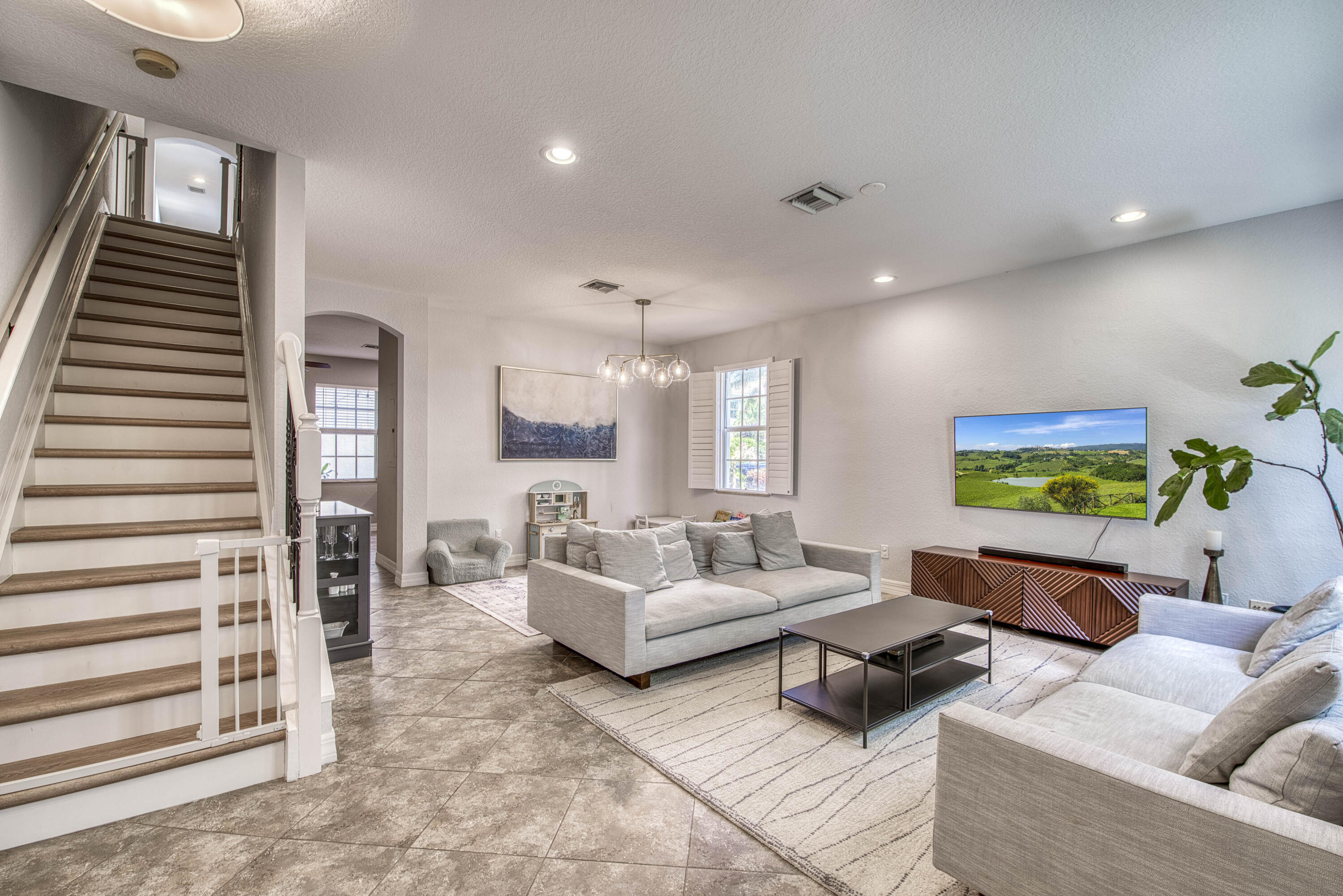 120 West Thatch Palm Circle Jupiter, FL 33458 - Photo 8 of 41 a living room with furniture and a flat screen tv