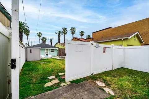 front view of house with a yard and potted plants