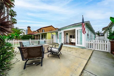 a view of a house with backyard and sitting area