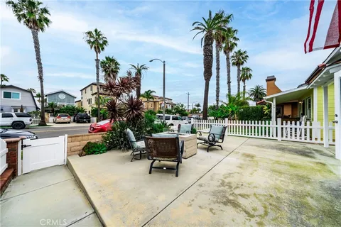 a view of a patio with a table and chairs and potted plants