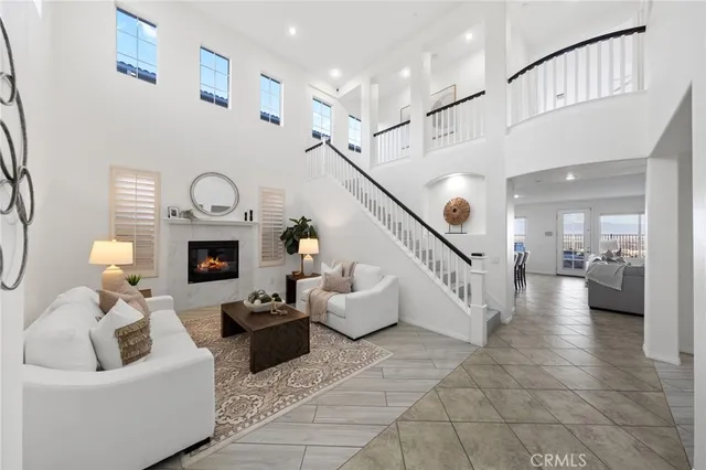 a living room with furniture potted plant and a chandelier