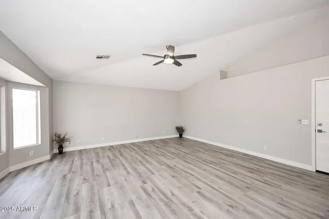 wooden floor in an empty room with a window
