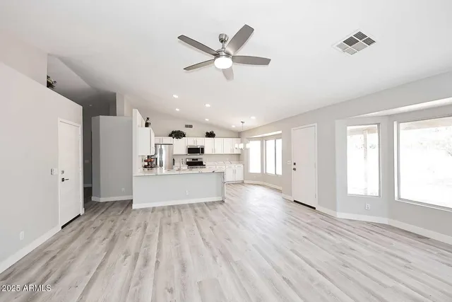 a view of kitchen with cabinets and wooden floor