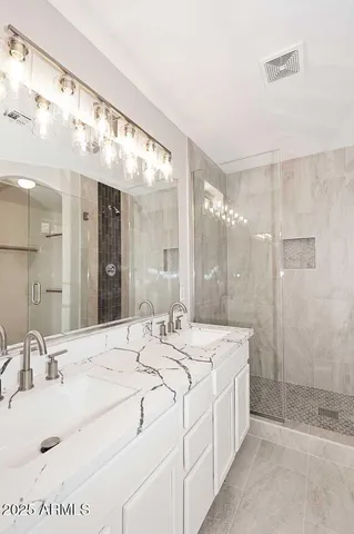a spacious bathroom with a sink mirror and shower