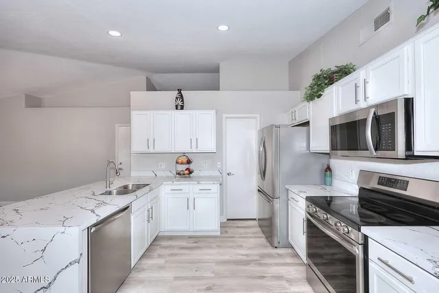 a kitchen with a sink stove and refrigerator