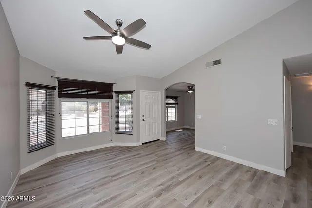 wooden floor in an empty room with a window