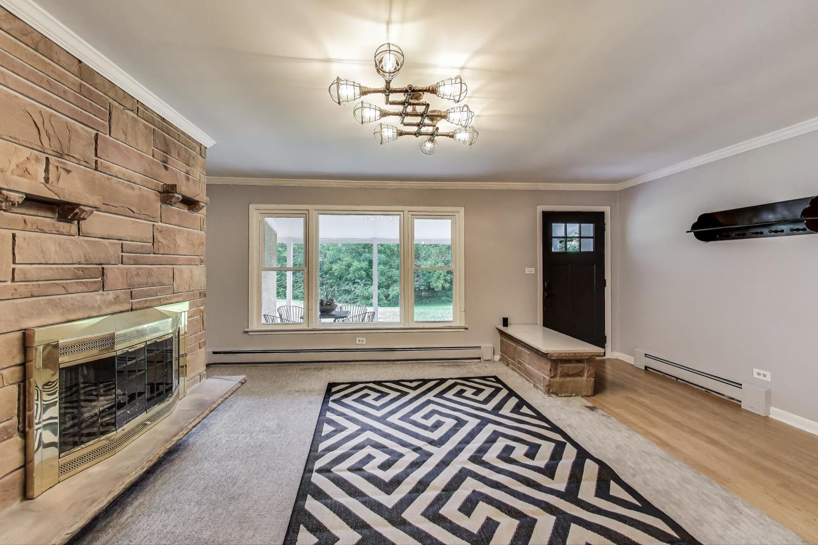 222 Bradwell Road Inverness, IL 60010 - Photo 11 of 46 a spacious bedroom with a bed and a fireplace