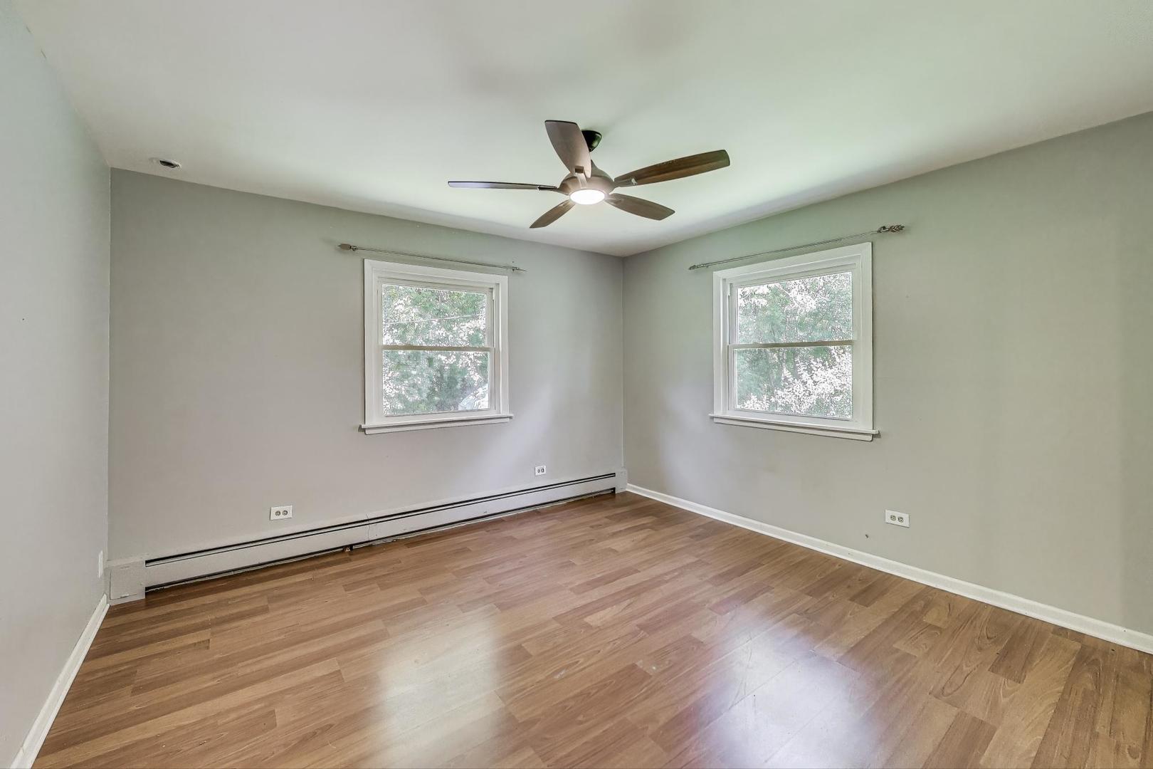 222 Bradwell Road Inverness, IL 60010 - Photo 25 of 46 an empty room with wooden floor ceiling fan and windows