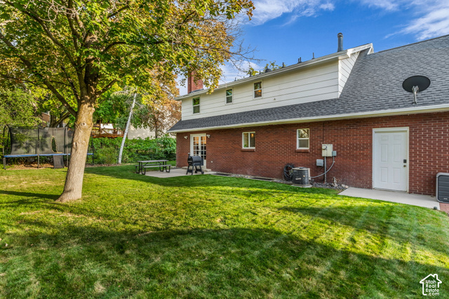 1073 Pineridge Road Sandy, UT 84094 - Photo 30 of 31 Expansive lawn with mature trees and a concrete patio
