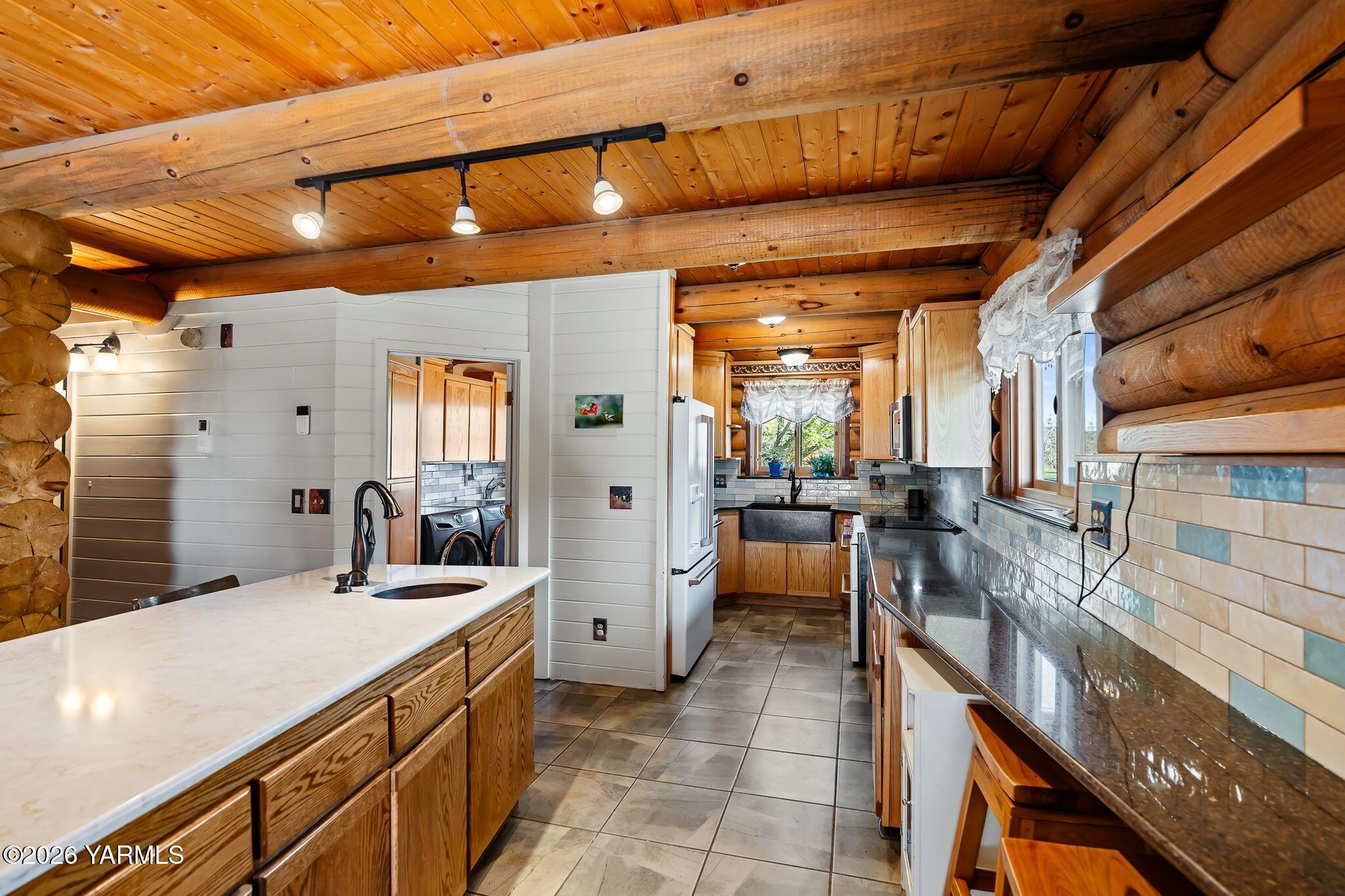 2550 Kays Road Wapato, WA 98951 - Photo 13 of 52 a room with lots of wooden furniture and a large window