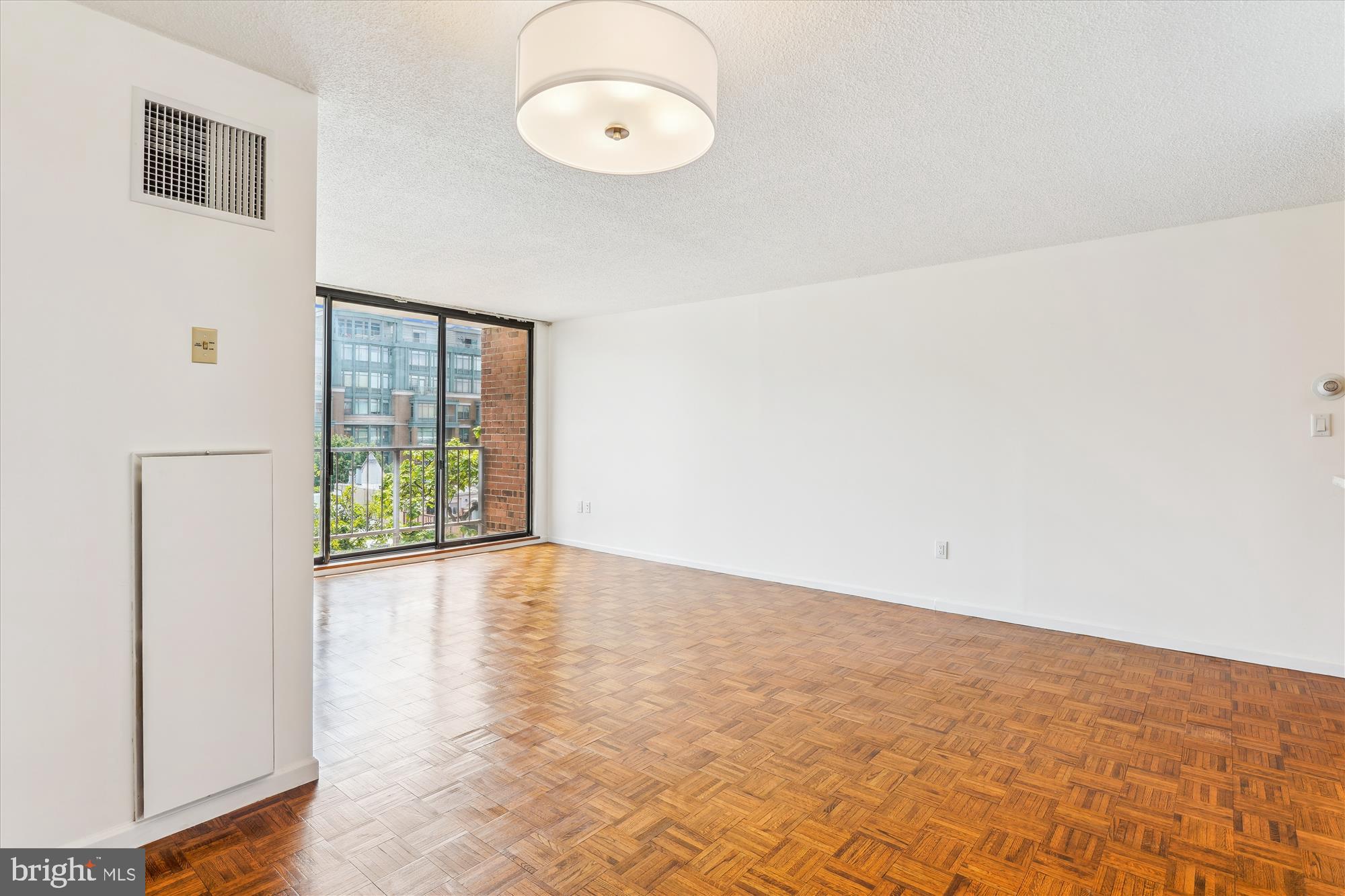 2555 Pennsylvania Avenue Northwest, Unit 816 Washington, DC 20037 - Photo 12 of 54 a view of an empty room with a window
