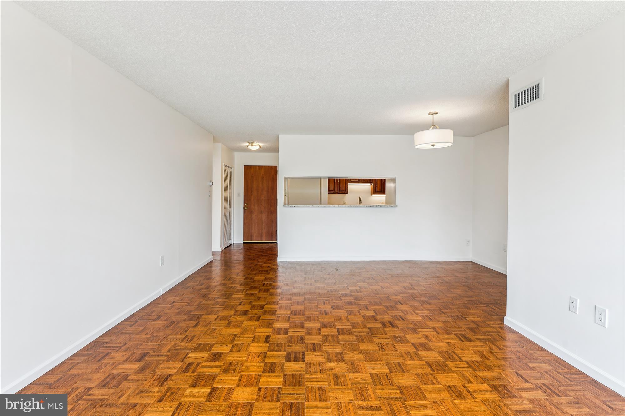 2555 Pennsylvania Avenue Northwest, Unit 816 Washington, DC 20037 - Photo 19 of 54 a view of a hallway with wooden floor