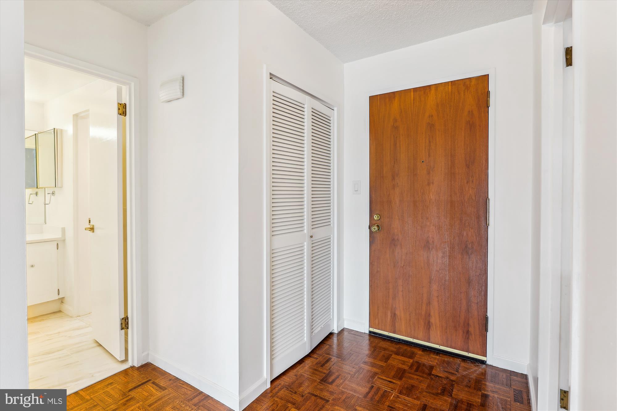 2555 Pennsylvania Avenue Northwest, Unit 816 Washington, DC 20037 - Photo 2 of 54 a view of a bedroom from the hallway