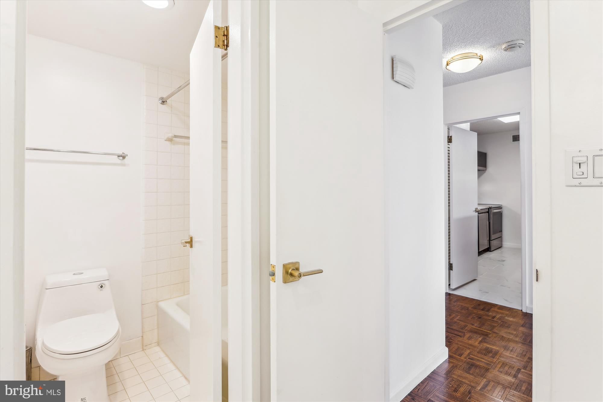 2555 Pennsylvania Avenue Northwest, Unit 816 Washington, DC 20037 - Photo 23 of 54 a bathroom with a granite countertop toilet a sink and a mirror