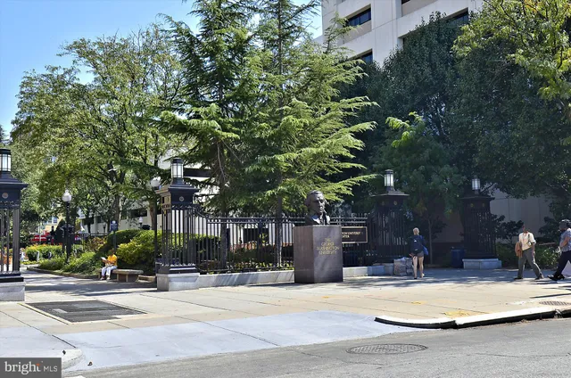a group of people sitting in front of retail shops
