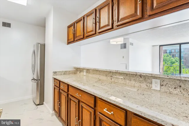 a view of a kitchen cabinets and a window