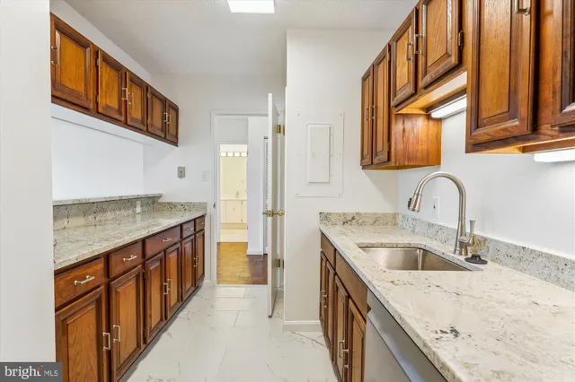 a kitchen with a sink stove top oven and a granite counter tops
