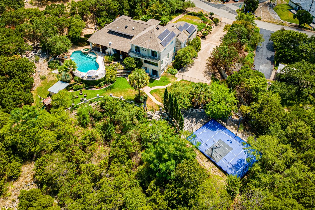 an aerial view of a house with a yard and swimming pool