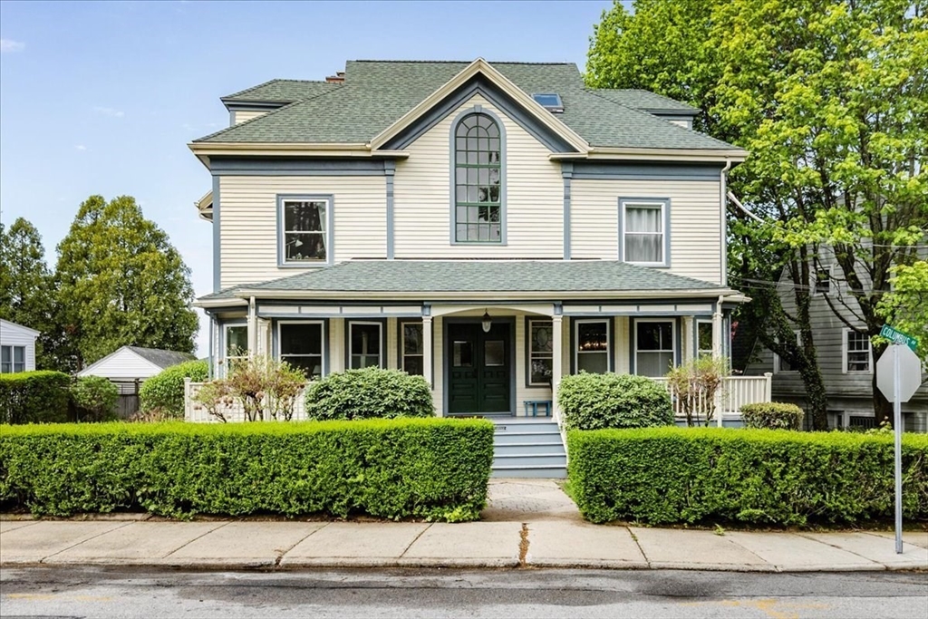 44 Baker Avenue, Unit 1 Beverly, MA 01915 - Photo 1 of 29 a front view of a house with a garden
