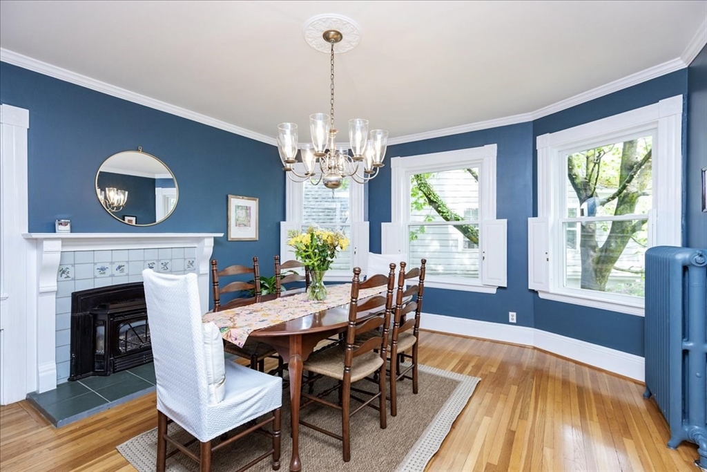 44 Baker Avenue, Unit 1 Beverly, MA 01915 - Photo 11 of 29 a view of a dining room with furniture a chandelier and wooden floor