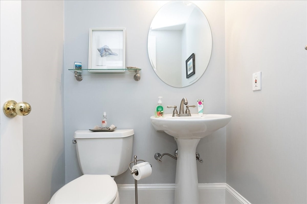 44 Baker Avenue, Unit 1 Beverly, MA 01915 - Photo 13 of 29 a bathroom with a sink mirror and toilet
