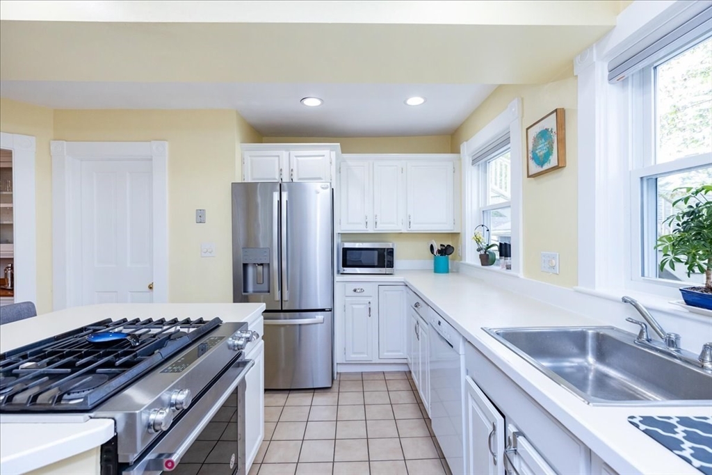 44 Baker Avenue, Unit 1 Beverly, MA 01915 - Photo 15 of 29 a kitchen with a sink stove and refrigerator