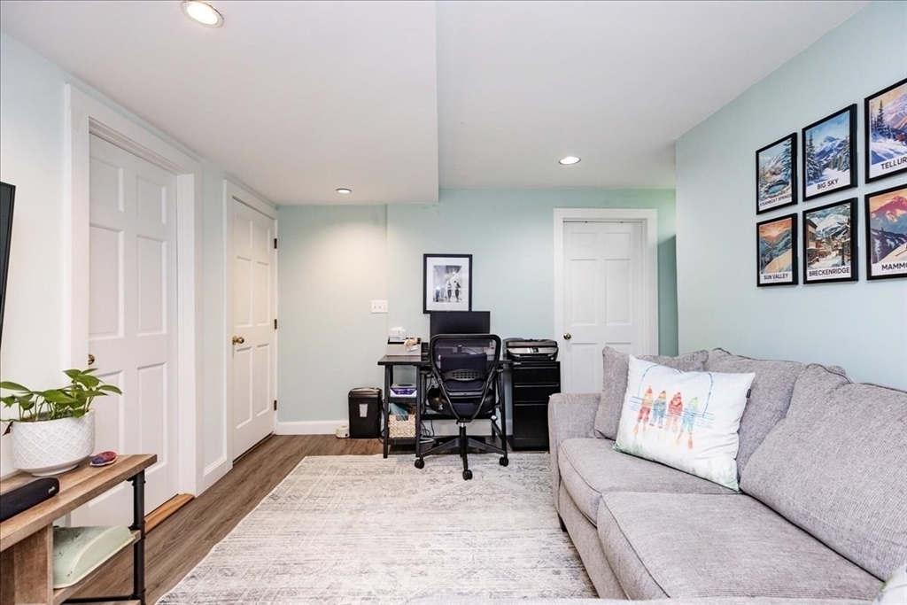 44 Baker Avenue, Unit 1 Beverly, MA 01915 - Photo 18 of 29 a living room with furniture and wooden floor
