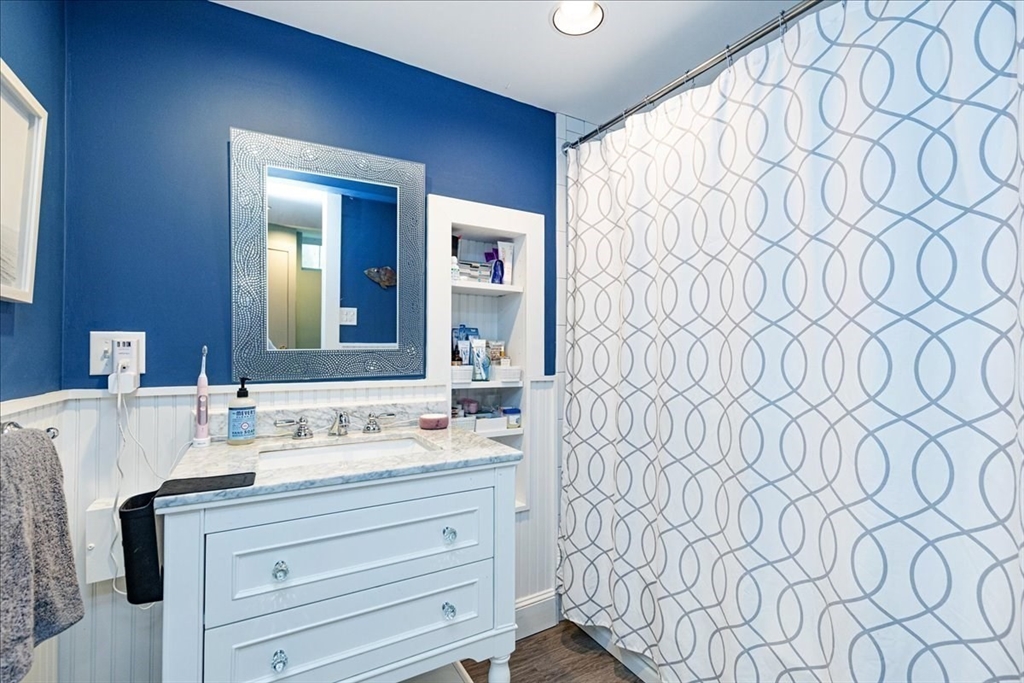 44 Baker Avenue, Unit 1 Beverly, MA 01915 - Photo 20 of 29 a bathroom with a sink and a mirror