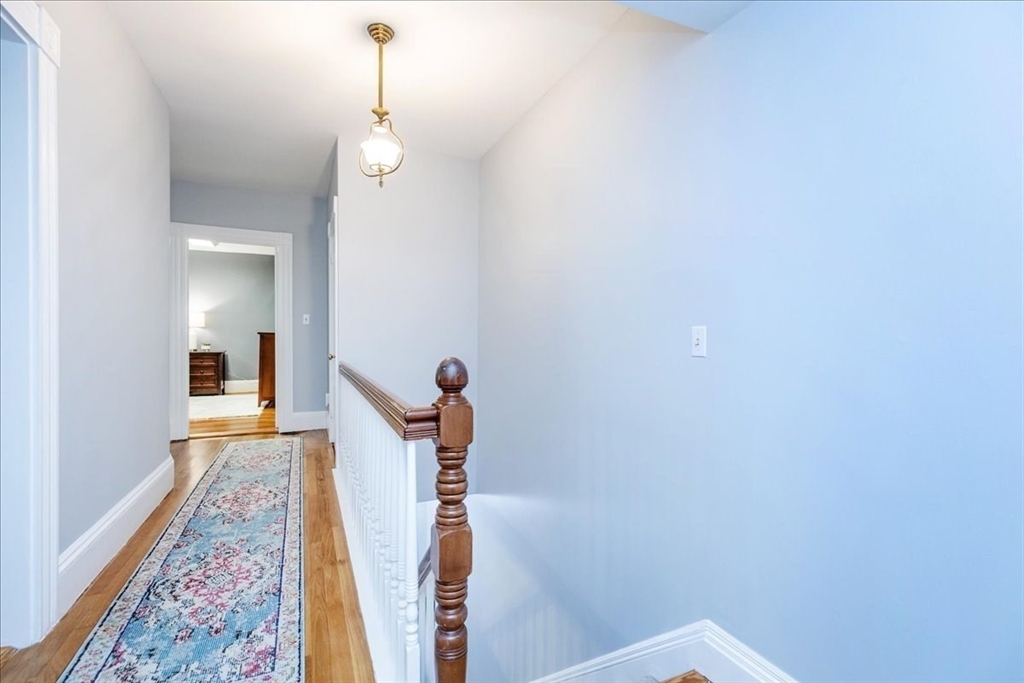 44 Baker Avenue, Unit 1 Beverly, MA 01915 - Photo 23 of 29 a view of a hallway with wooden floor and a carpet