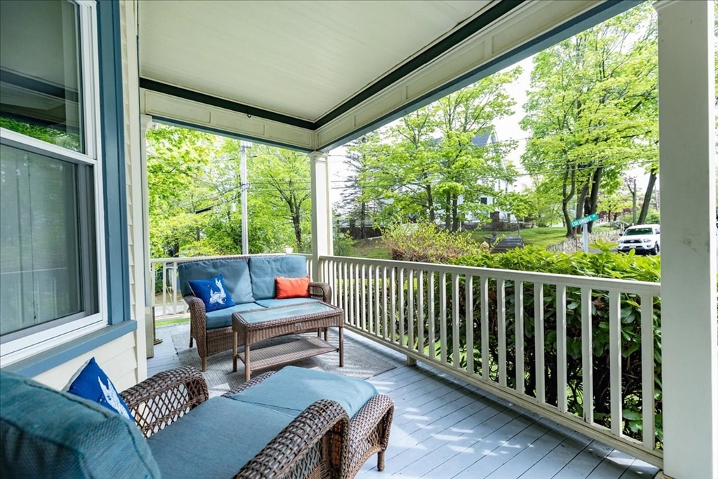 44 Baker Avenue, Unit 1 Beverly, MA 01915 - Photo 5 of 29 a balcony with wooden floor and outdoor seating