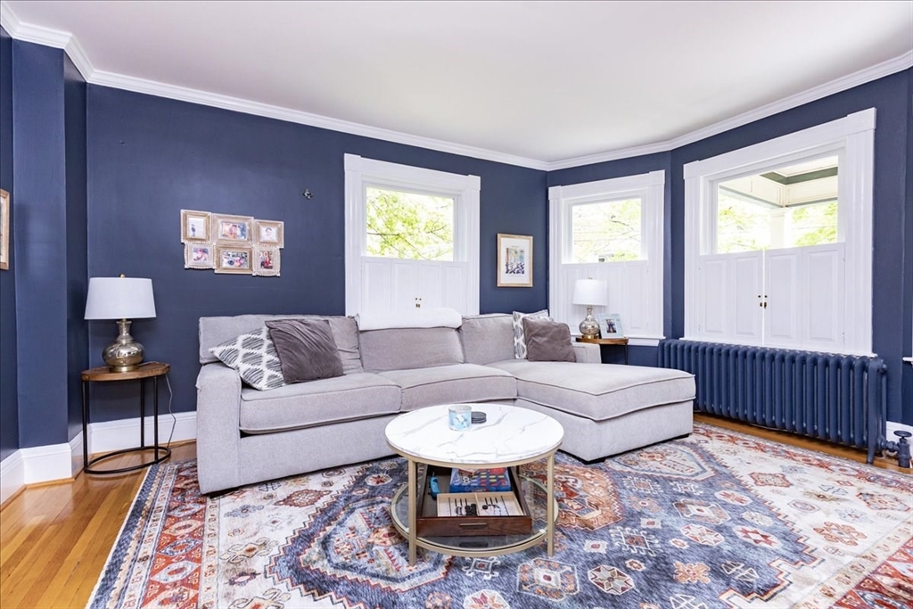 44 Baker Avenue, Unit 1 Beverly, MA 01915 - Photo 7 of 29 a living room with furniture and a large window