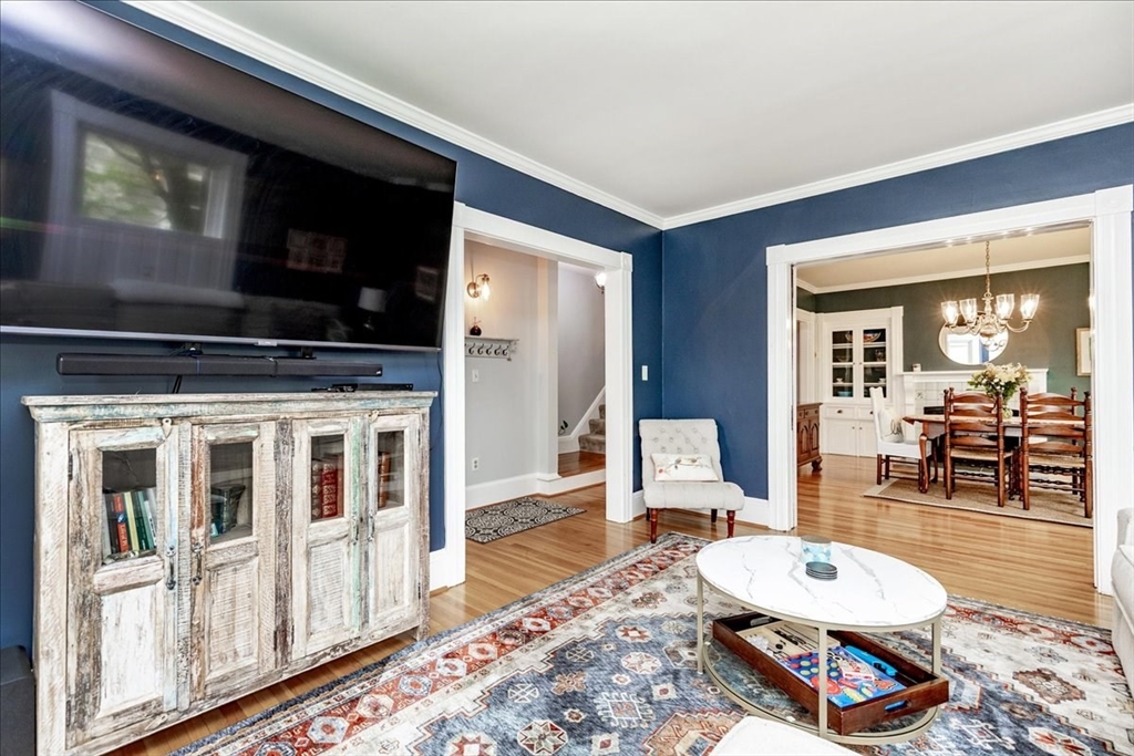 44 Baker Avenue, Unit 1 Beverly, MA 01915 - Photo 9 of 29 a living room with furniture a flat screen tv and a rug