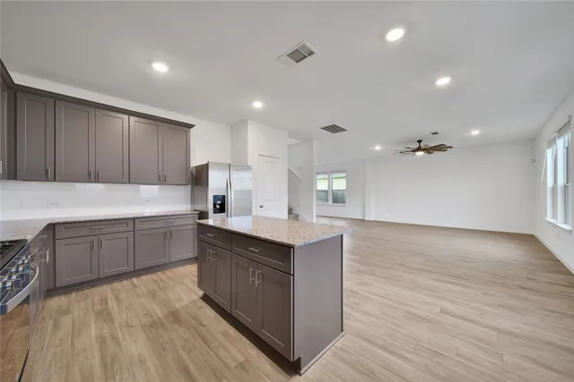 a kitchen with a sink cabinets and wooden floor