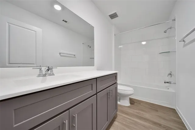 a bathroom with a sink a toilet a shower and a mirror