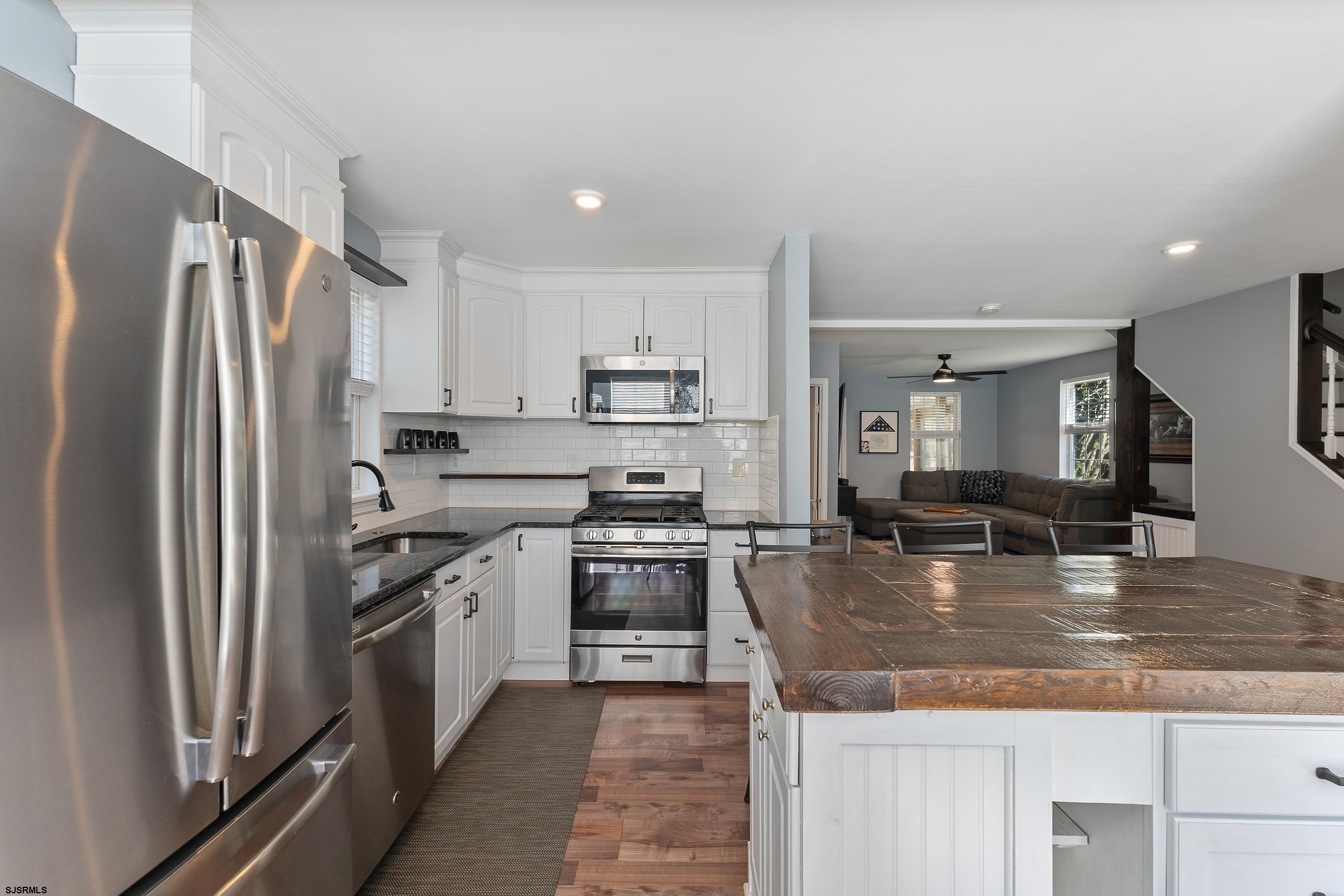 305 East Ridgewood Avenue Galloway Township, NJ 08205 - Photo 11 of 54 a kitchen with stainless steel appliances granite countertop a refrigerator a stove and a sink