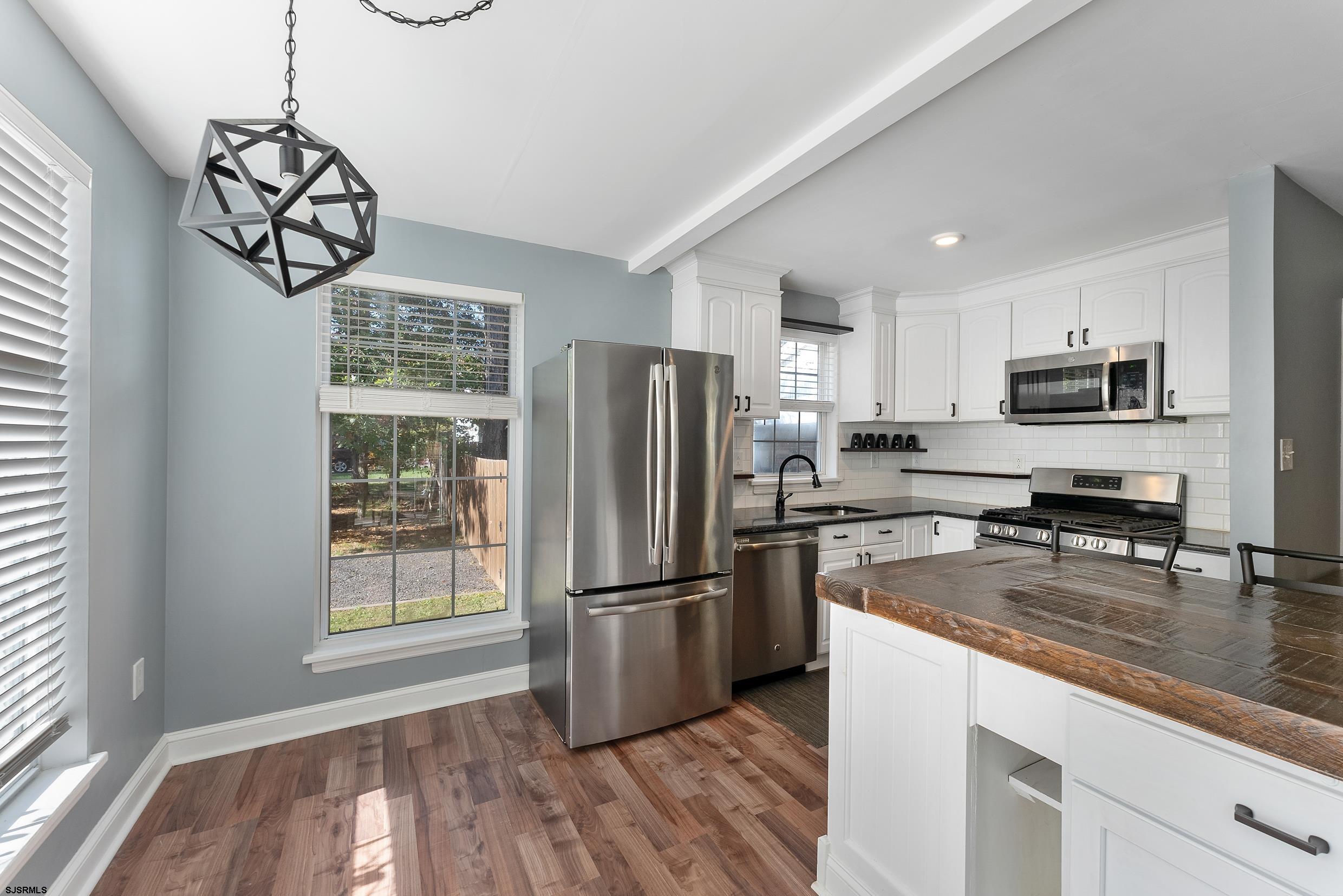 305 East Ridgewood Avenue Galloway Township, NJ 08205 - Photo 12 of 54 a kitchen with stainless steel appliances granite countertop a refrigerator a stove top oven a sink and dishwasher