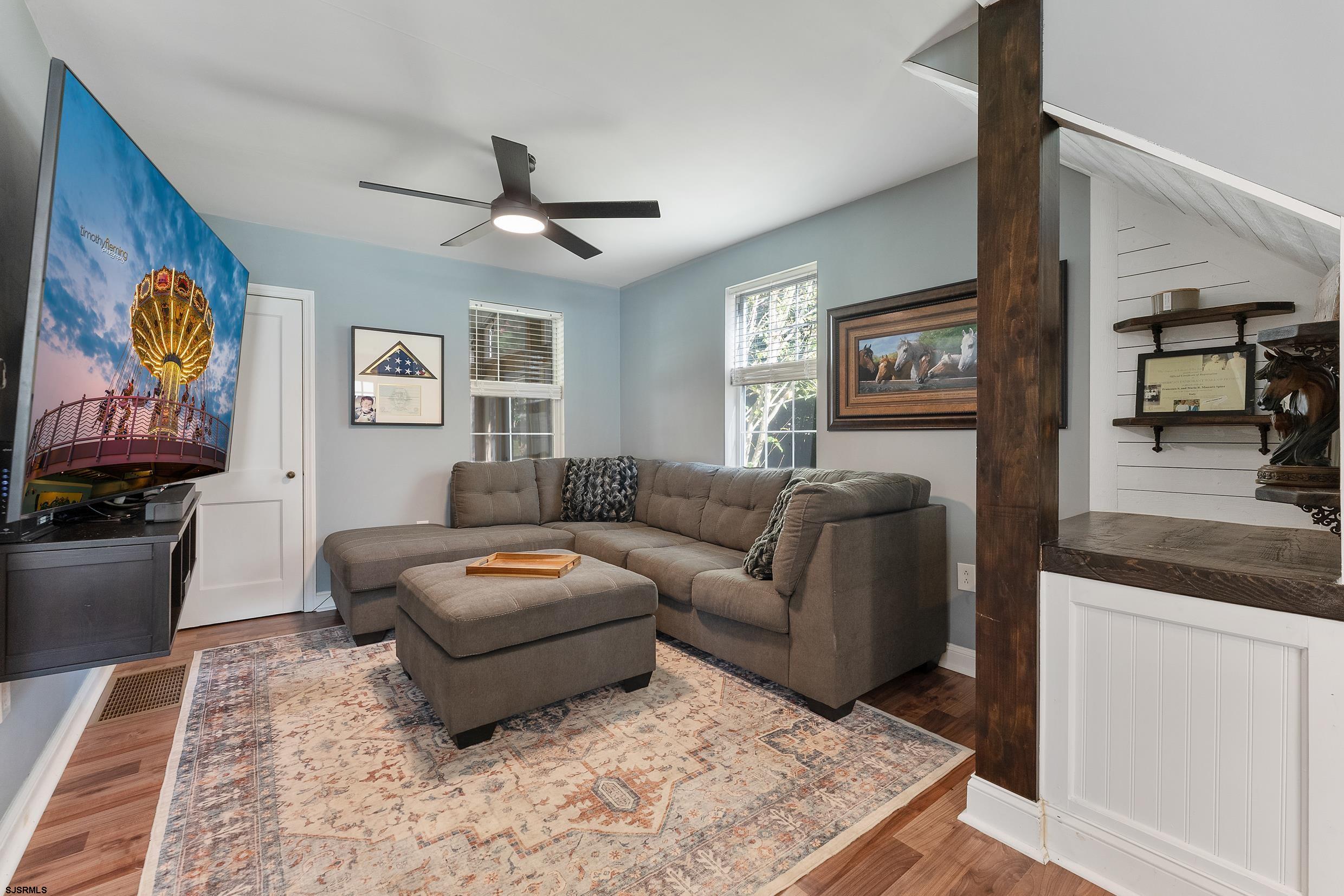 305 East Ridgewood Avenue Galloway Township, NJ 08205 - Photo 14 of 54 a living room with furniture and painting on the wall