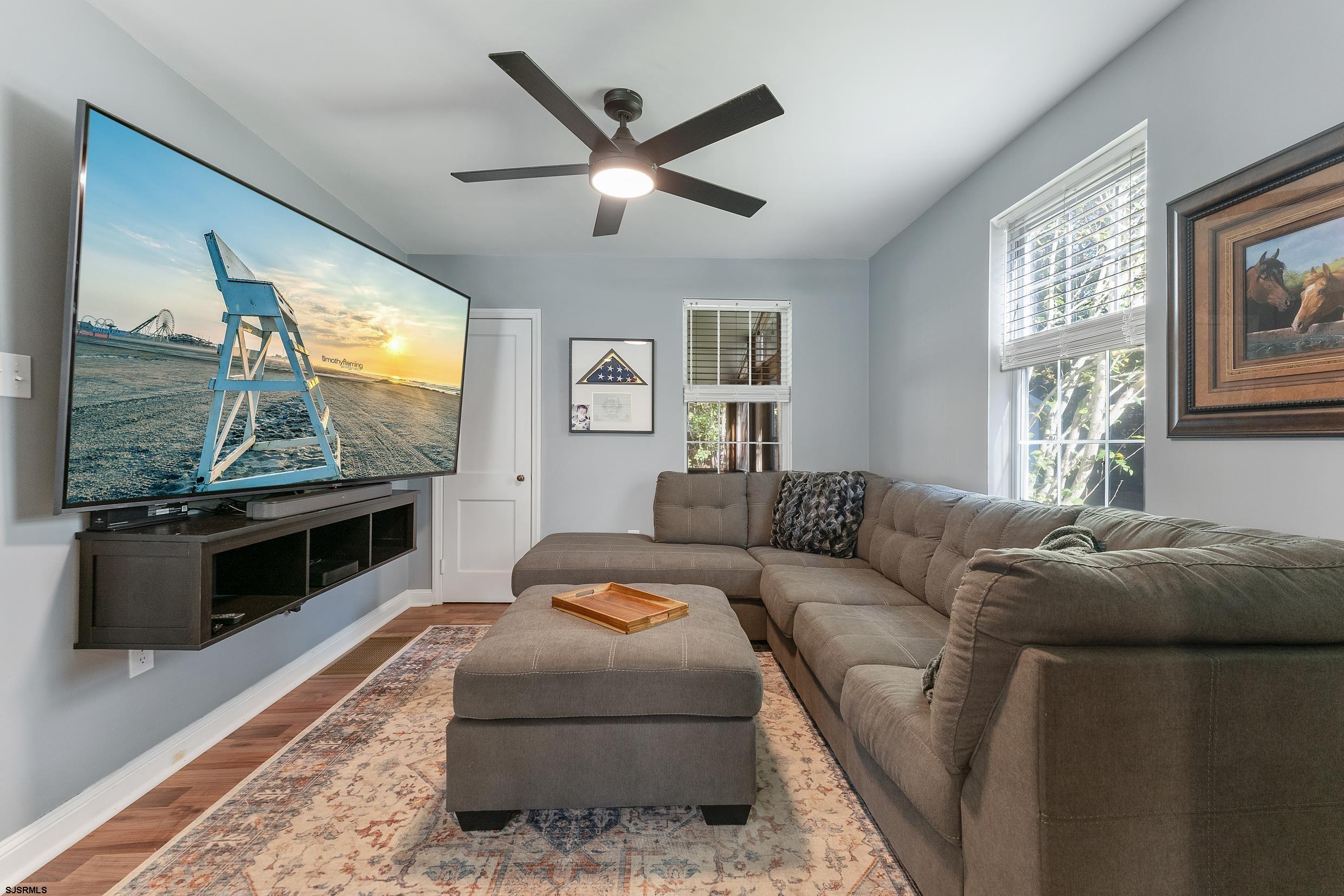 305 East Ridgewood Avenue Galloway Township, NJ 08205 - Photo 15 of 54 a living room with furniture a large window and a flat screen tv