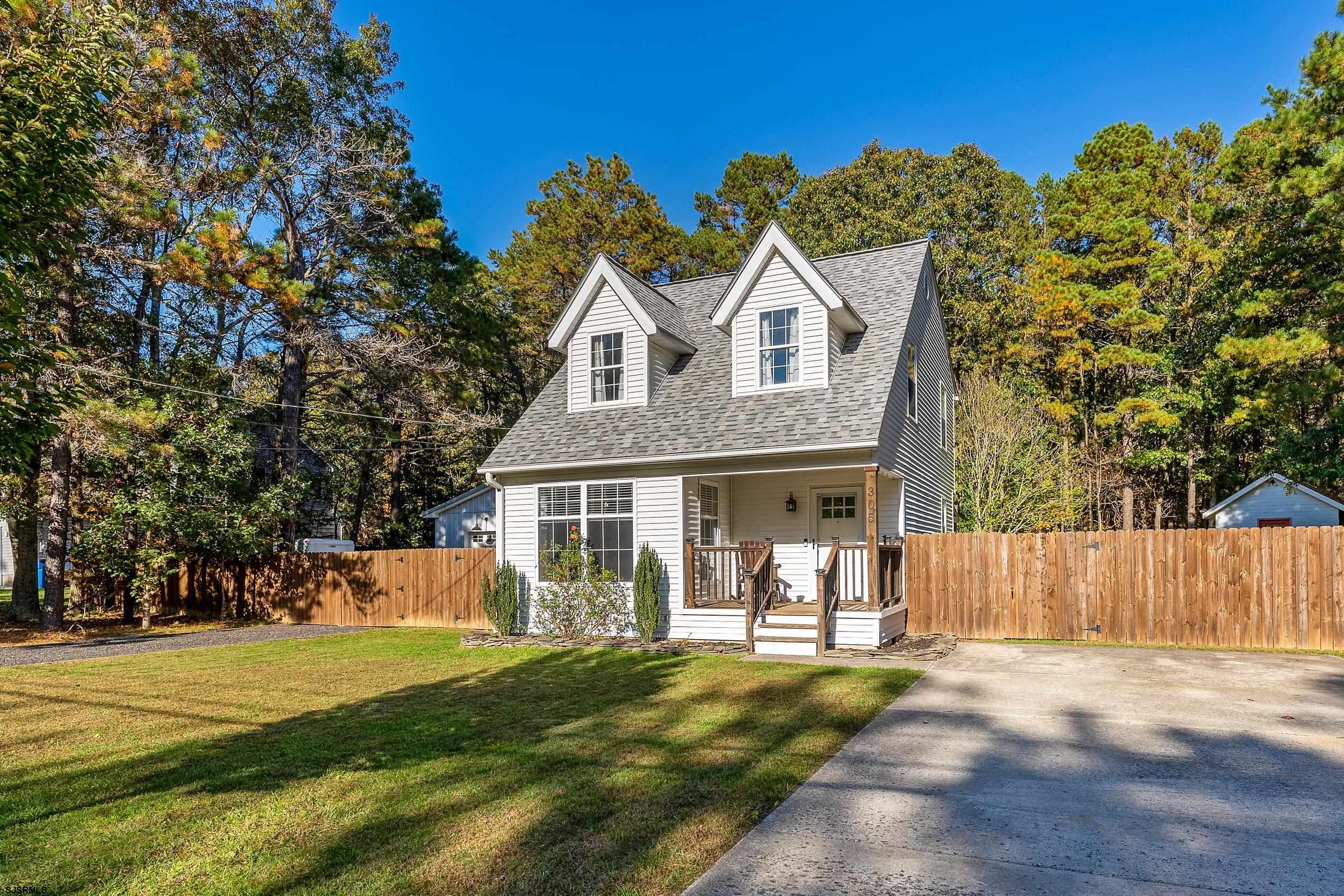 305 East Ridgewood Avenue Galloway Township, NJ 08205 - Photo 2 of 54 a view of a house with a yard and wooden fence