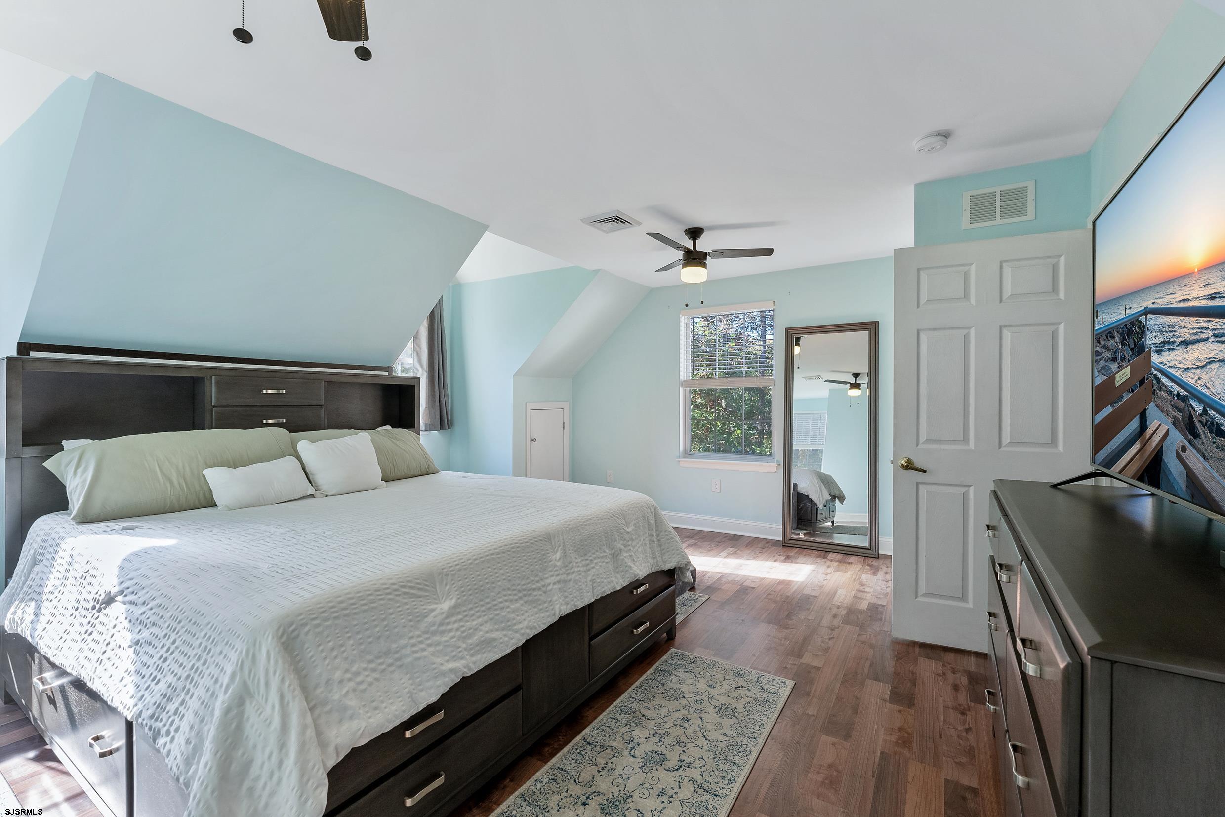 305 East Ridgewood Avenue Galloway Township, NJ 08205 - Photo 22 of 54 a bedroom with a bed and a flat tv screen on dresser