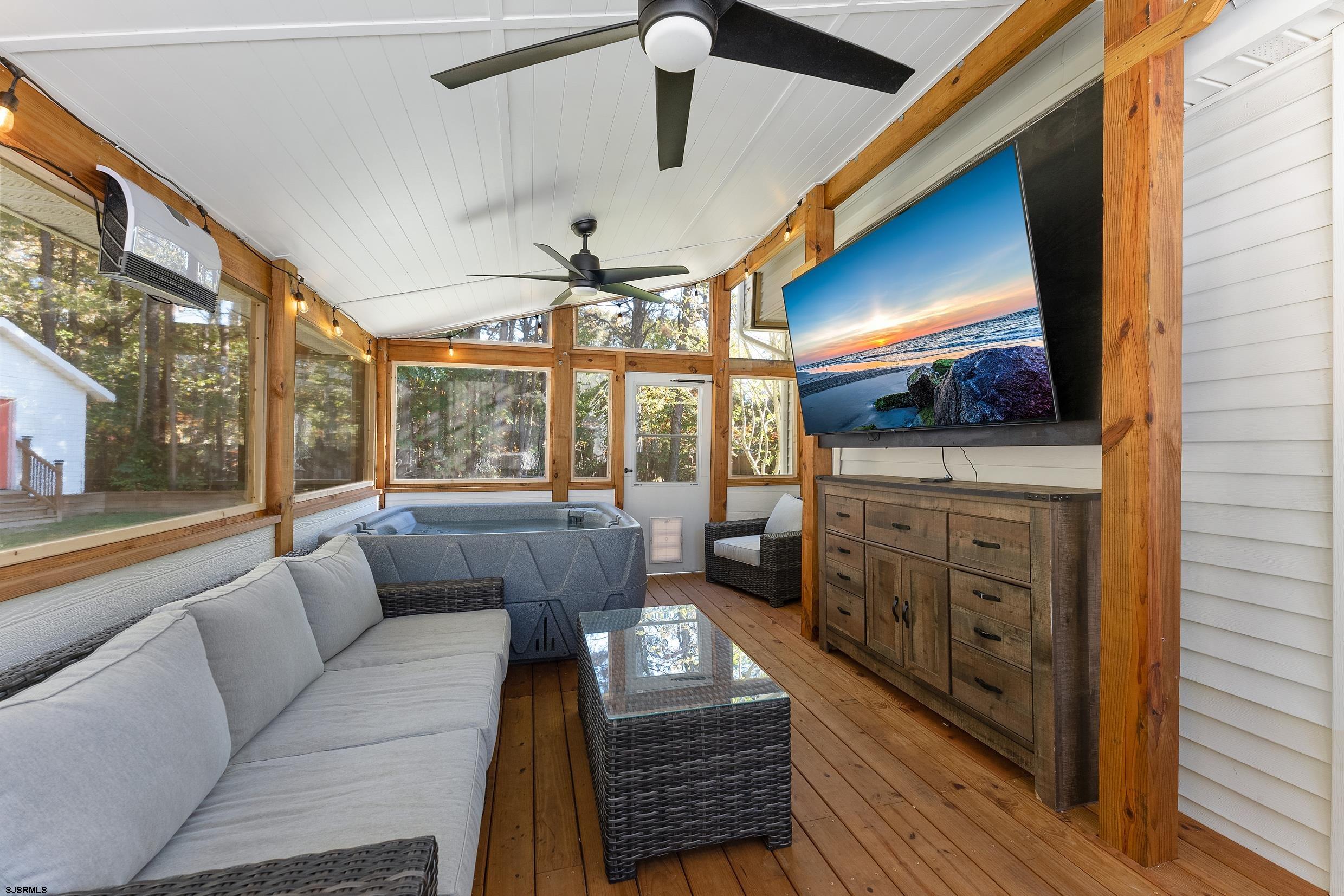 305 East Ridgewood Avenue Galloway Township, NJ 08205 - Photo 29 of 54 a living room with furniture and a flat screen tv