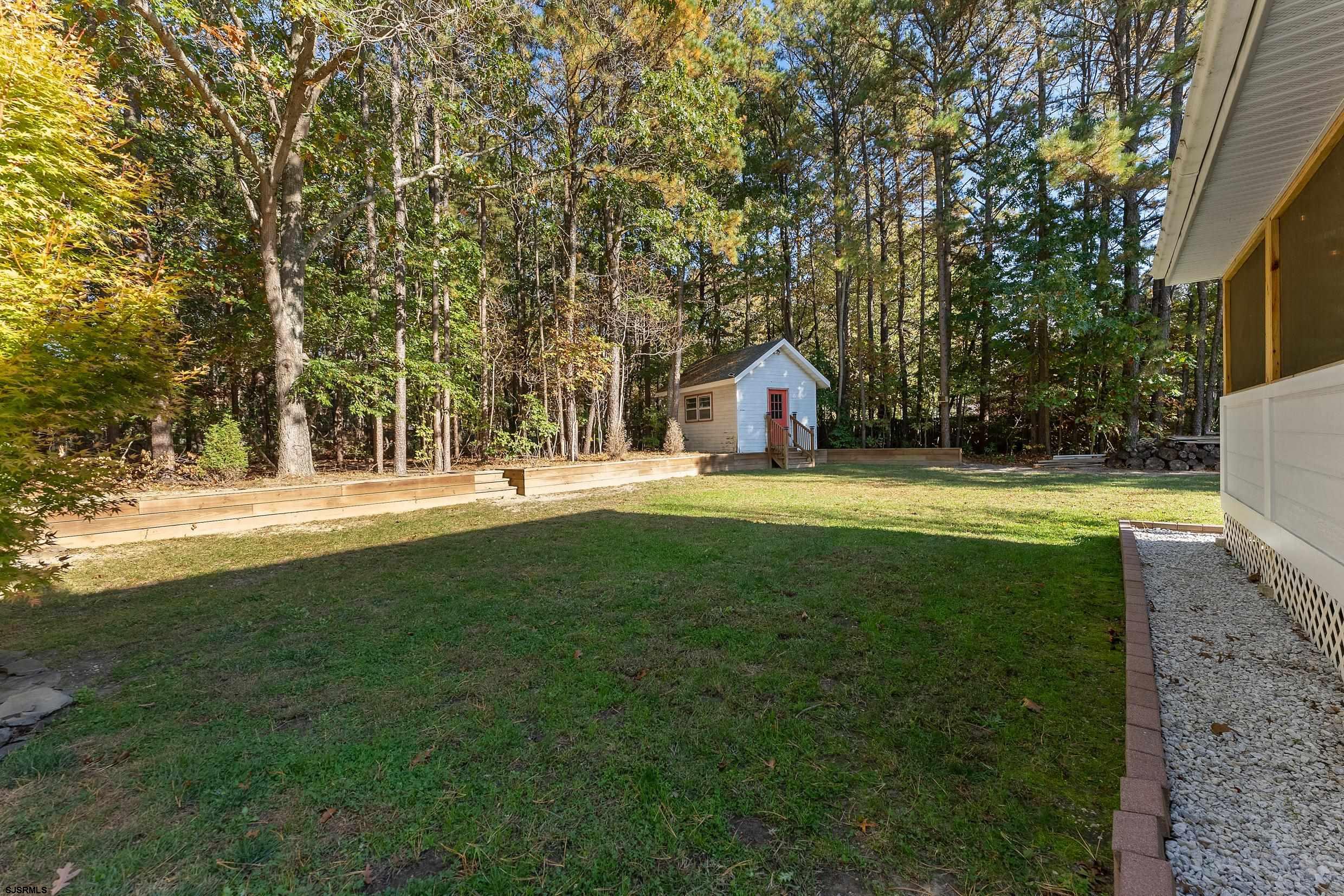 305 East Ridgewood Avenue Galloway Township, NJ 08205 - Photo 36 of 54 a view of yard with swimming pool and green space