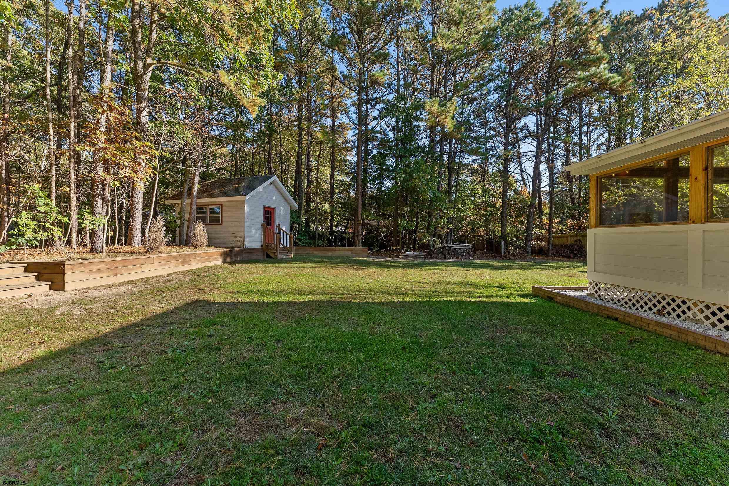 305 East Ridgewood Avenue Galloway Township, NJ 08205 - Photo 37 of 54 a view of a house with a big yard and large trees