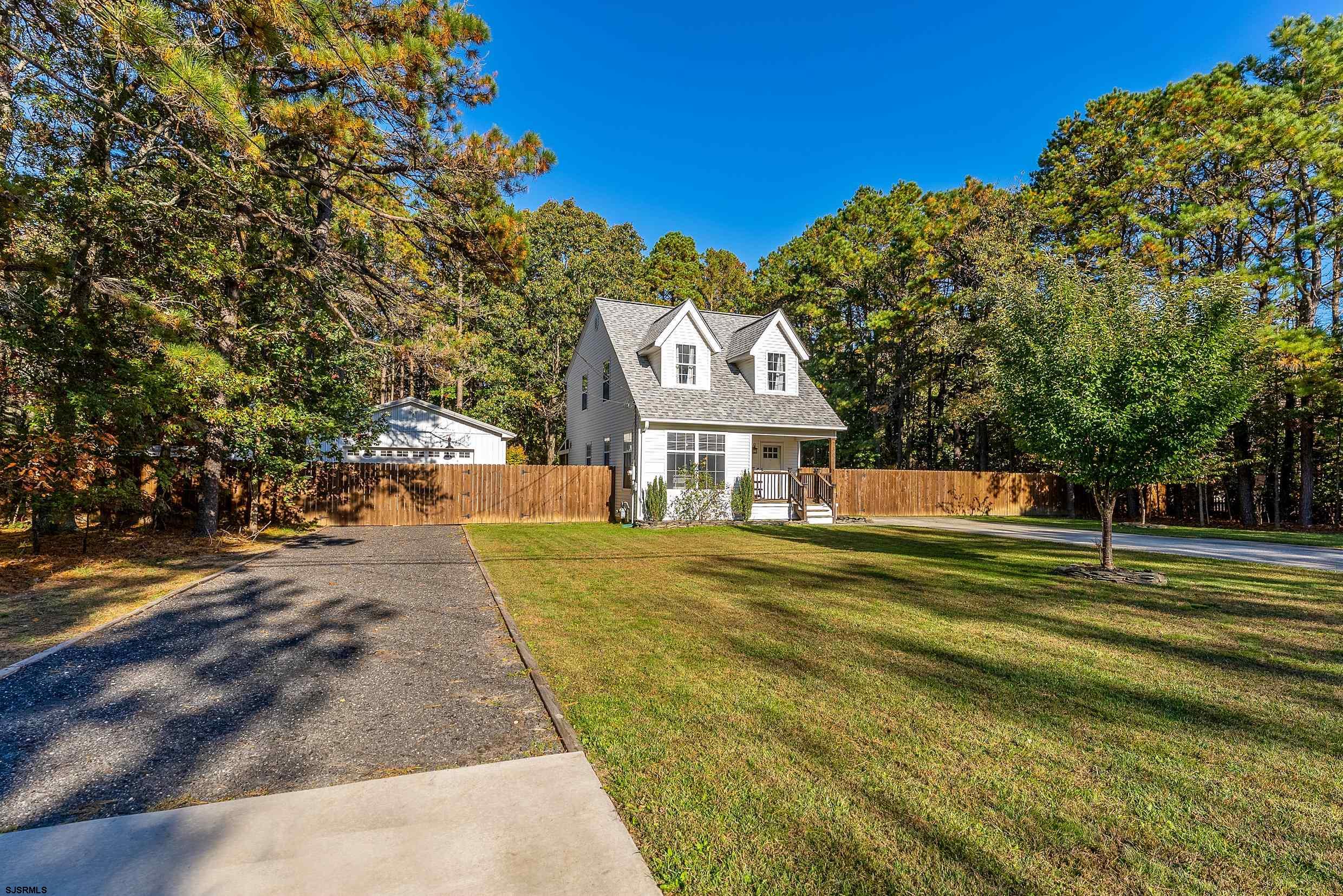305 East Ridgewood Avenue Galloway Township, NJ 08205 - Photo 4 of 54 a front view of a house with a yard