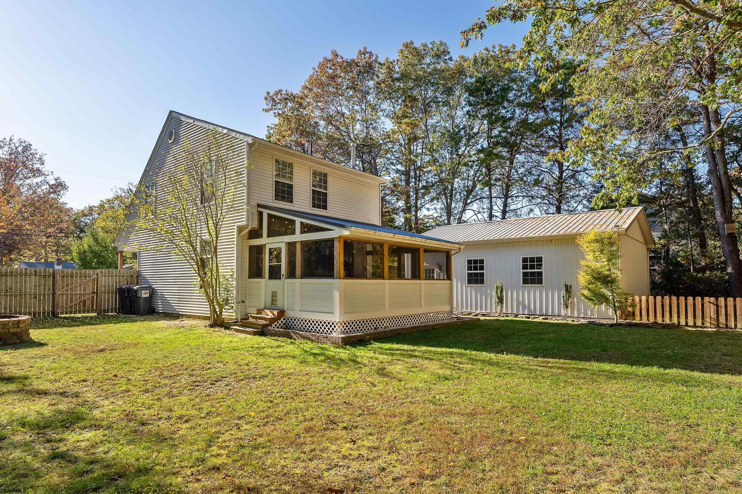 305 East Ridgewood Avenue Galloway Township, NJ 08205 - Photo 43 of 54 a front view of a house with a yard