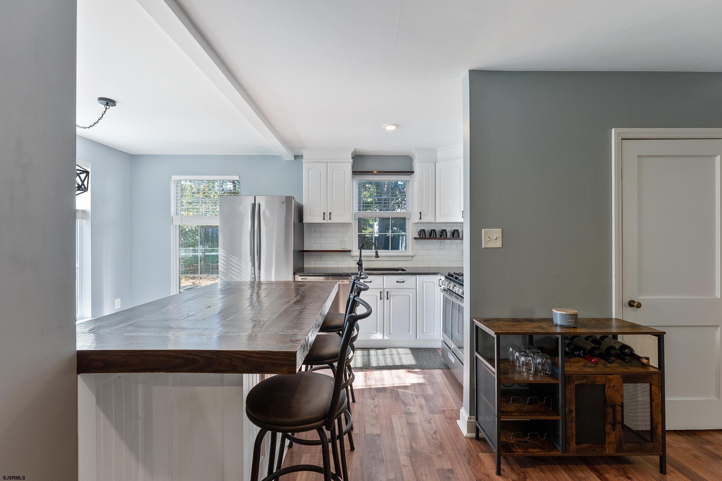 305 East Ridgewood Avenue Galloway Township, NJ 08205 - Photo 7 of 54 a view of a dining room with furniture and wooden floor