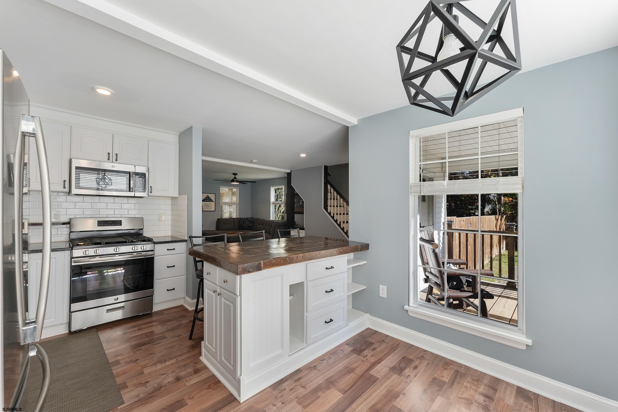 305 East Ridgewood Avenue Galloway Township, NJ 08205 - Photo 9 of 54 a kitchen with stainless steel appliances granite countertop a stove and a refrigerator